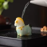 tang style handcrafted color changing horse tea pet on wooden tea table