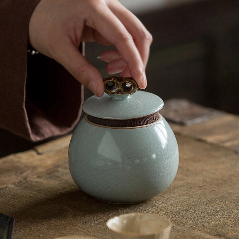 top view of open green ceramic tea jar