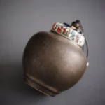 handcrafted traditional brown ceramic tea jar with cloth lid