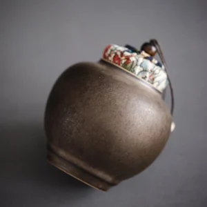 handcrafted traditional brown ceramic tea jar with cloth lid
