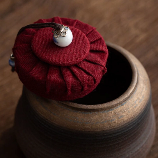 Traditional Chinese tea jar displayed on wooden background
