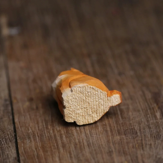 Two wooden cat tea pets displayed as cute decor on an office desk