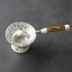 full view of vintage embossed goldfish loose leaf tea strainer with base