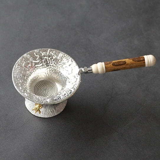 full view of vintage embossed goldfish loose leaf tea strainer with base