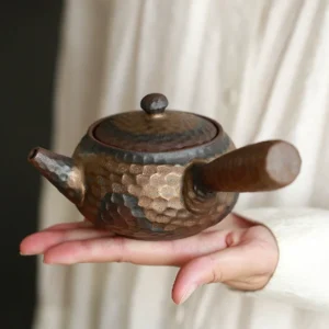 vintage hand hammered clay kyusu teapot 250ml side view held in hand