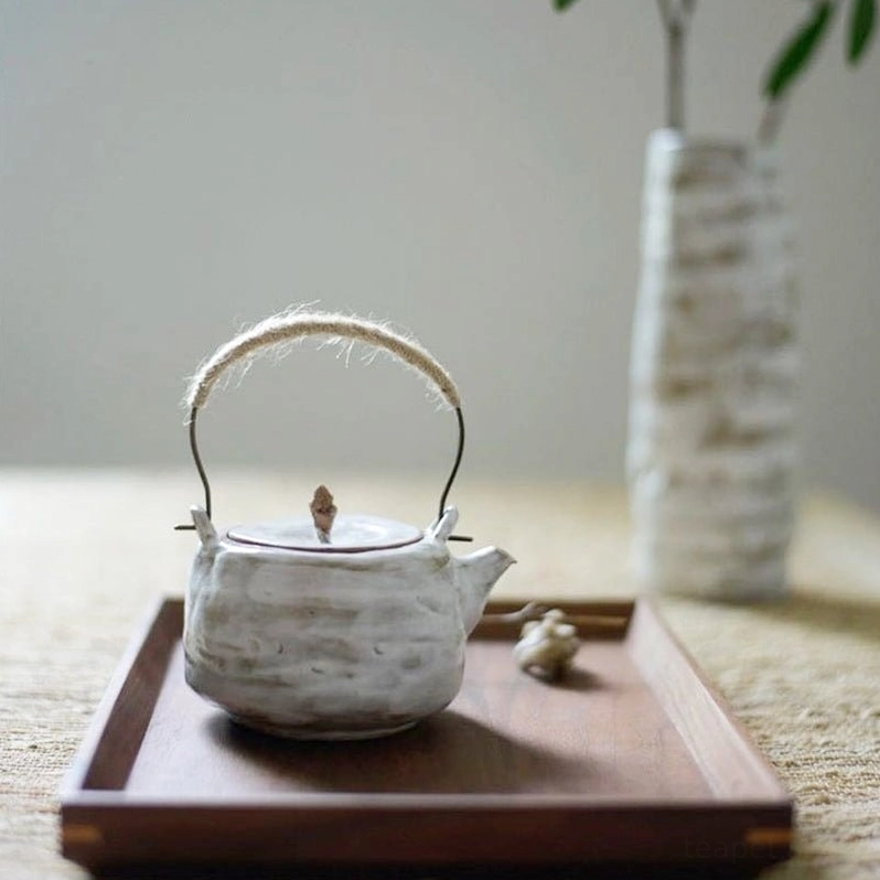wabi-sabi ceramic tea pot close up of hand textured ceramic surface