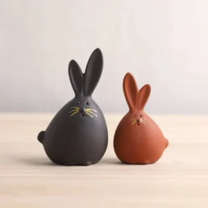Handcrafted warm brown matte ceramic rabbit tea pet on wooden tea desk