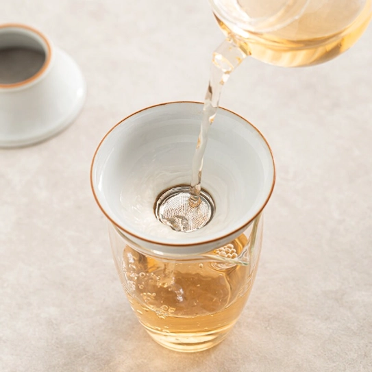 white ceramic loose leaf tea strainer side view