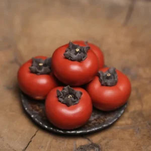 Handcrafted Yixing purple clay persimmon tea pet main view with lifelike ripe red persimmon design
