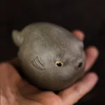 handmade yixing purple clay puffer fish tea pet main view on wooden tea table