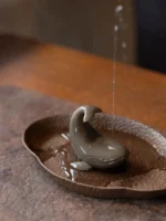 Handcrafted Yixing purple clay whale tea pet on wooden tea tray main view
