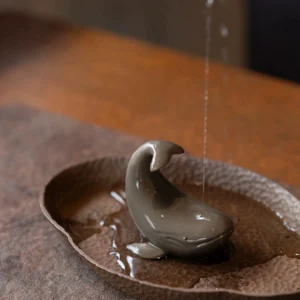 Handcrafted Yixing purple clay whale tea pet on wooden tea tray main view