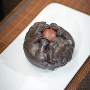 hand-carved yixing zisha double pixiu tea pet main view on bamboo tea mat