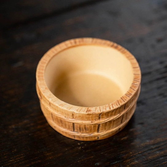 zisha gourd loose leaf tea strainer resting on matching wood effect holder